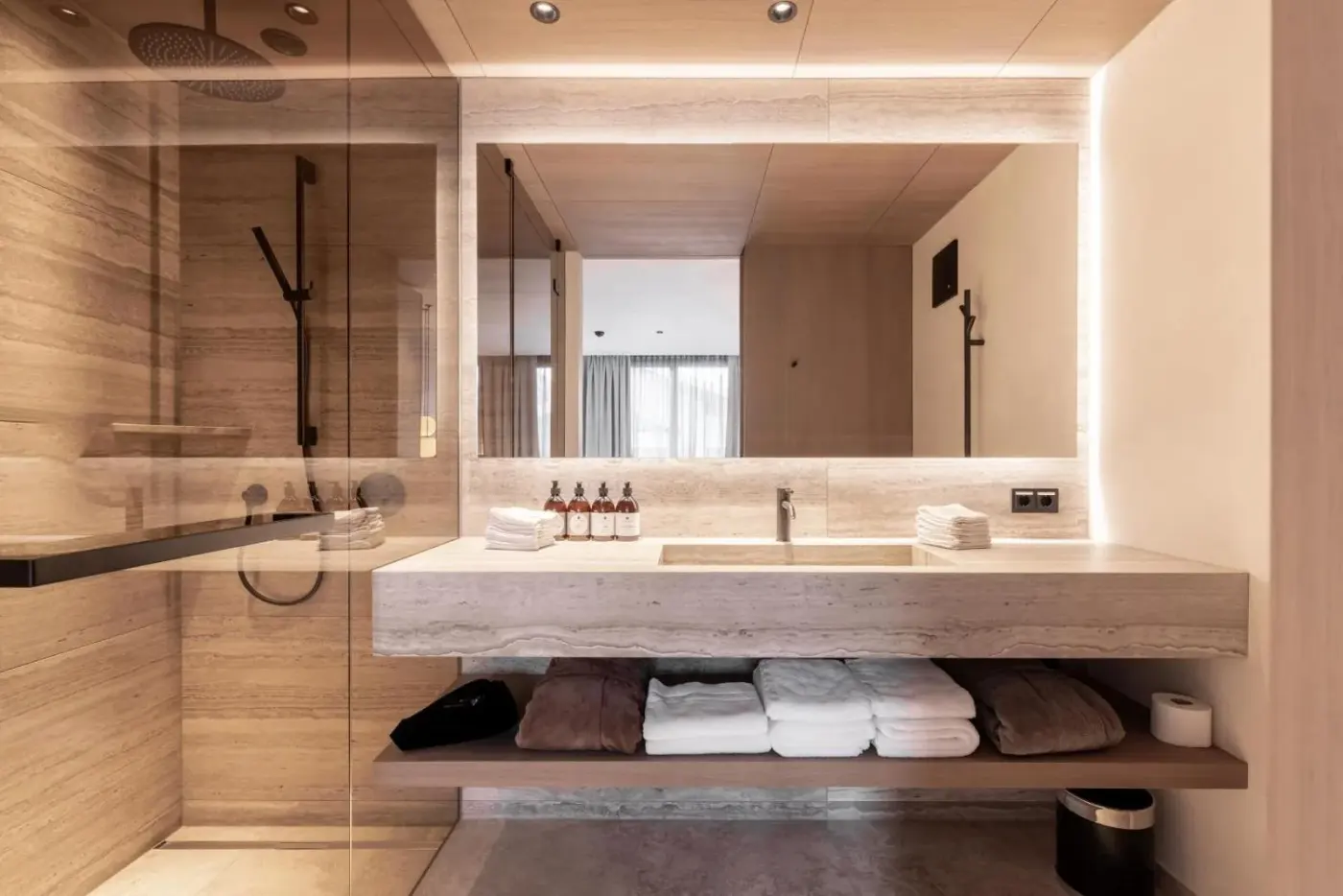 Bathroom with a glass shower, broad mirror and double vanity at Domenigs Luxury Apartments in Fiss, Austria.