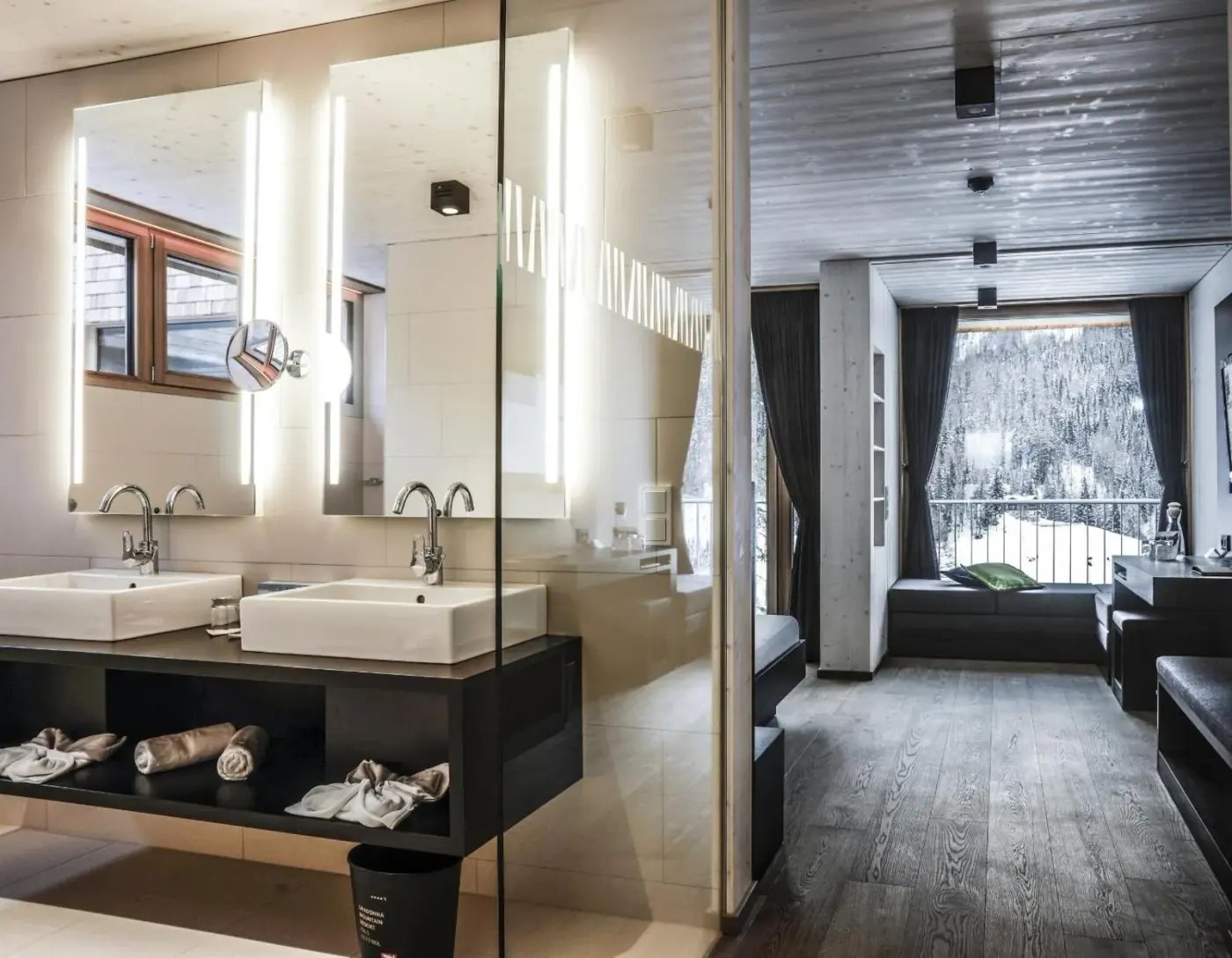 Bathroom with twin basins and a large mountain-facing window at Gradonna Mountain Resort Chalets and Hotel in Kals am Großglockner, Austria.