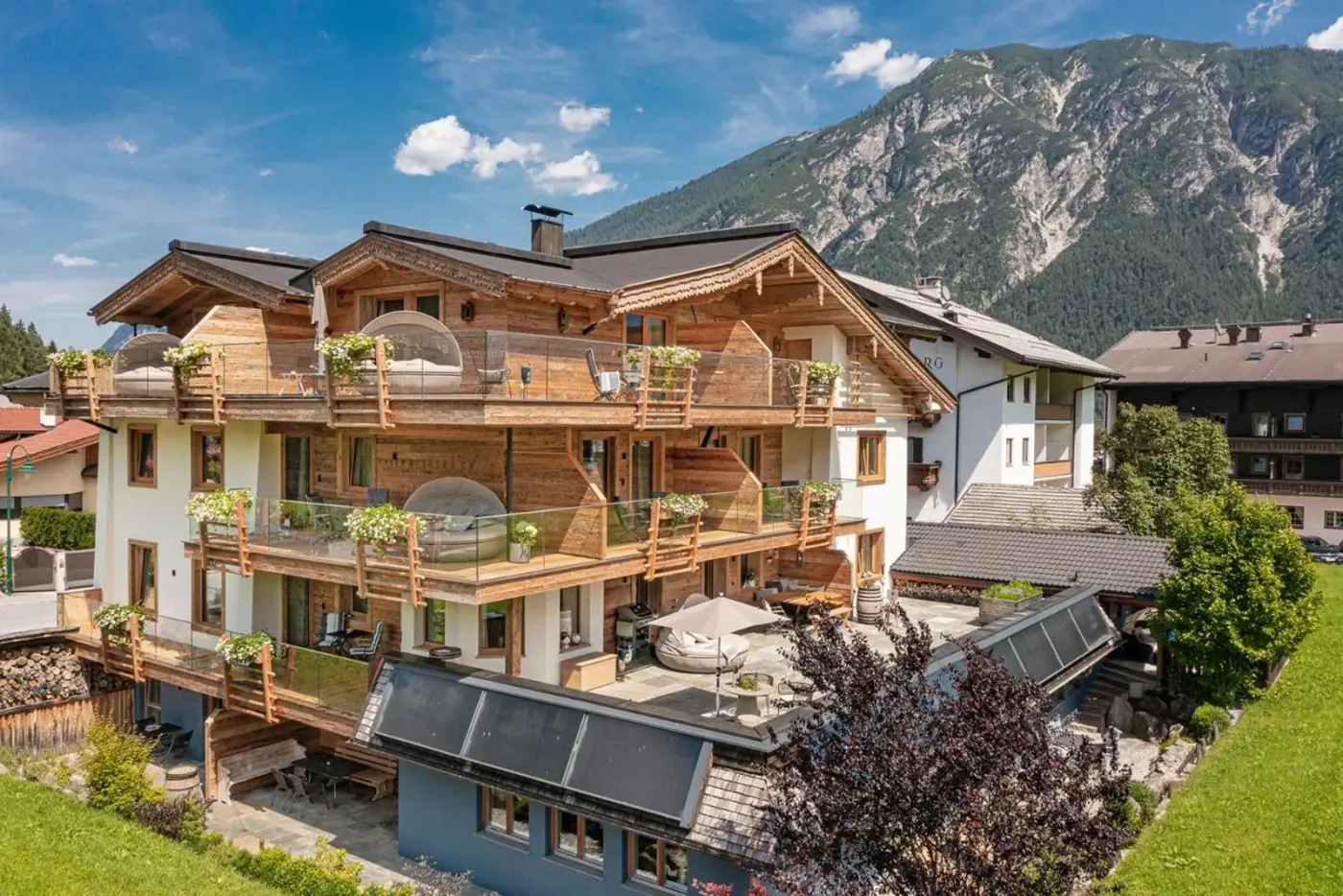 Chalet-style exterior with balconies and a mountain backdrop at Meerberg in Pertisau am Achensee, Austria.