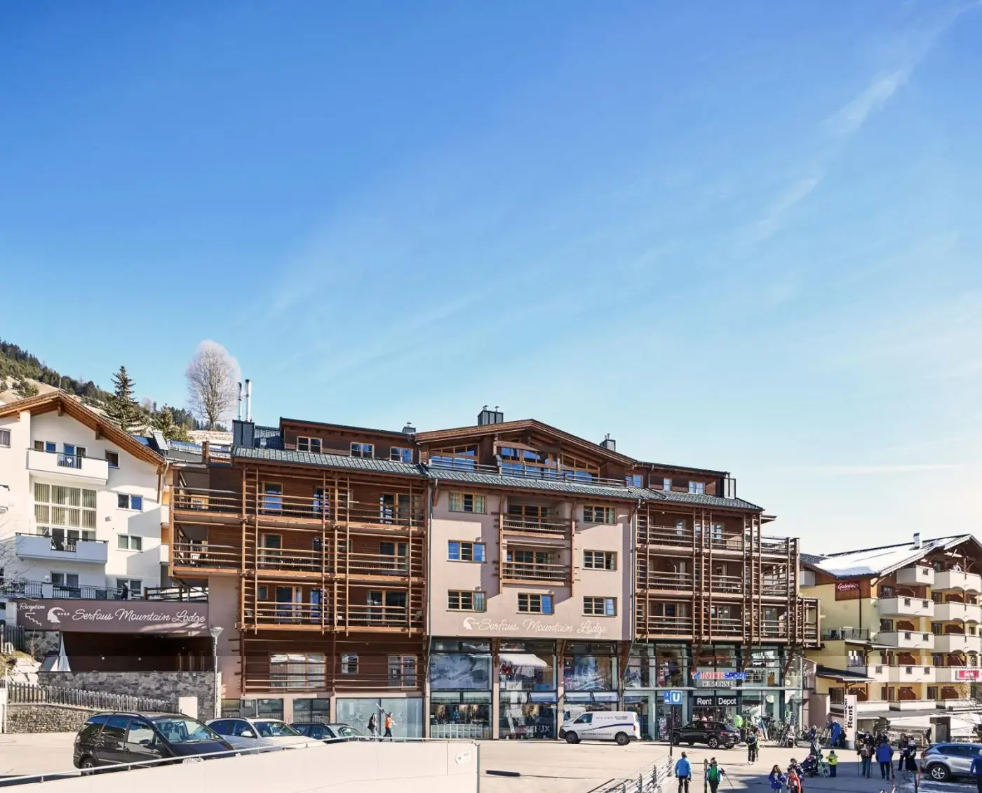 Apartment lodge with timber balcony screens in the village centre at Serfaus Mountain Lodge in Serfaus, Austria.