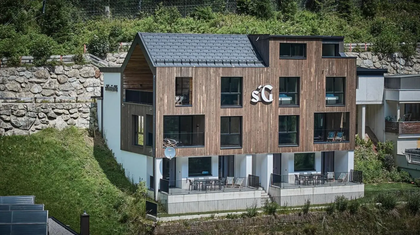 Timber-clad exterior beside a green hillside at sGmiatli Hideaway Apartment in Kappl, Austria.